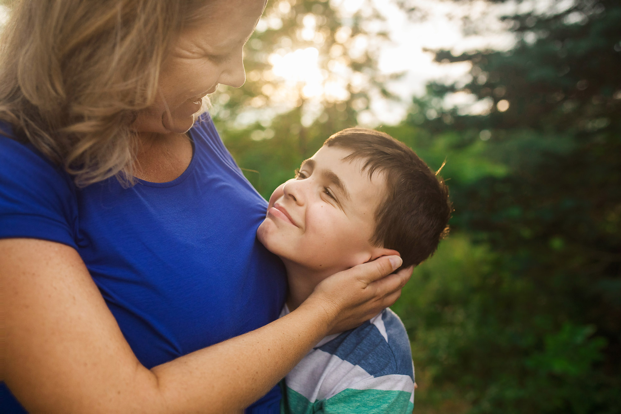mom hugging young son outdoor portrait