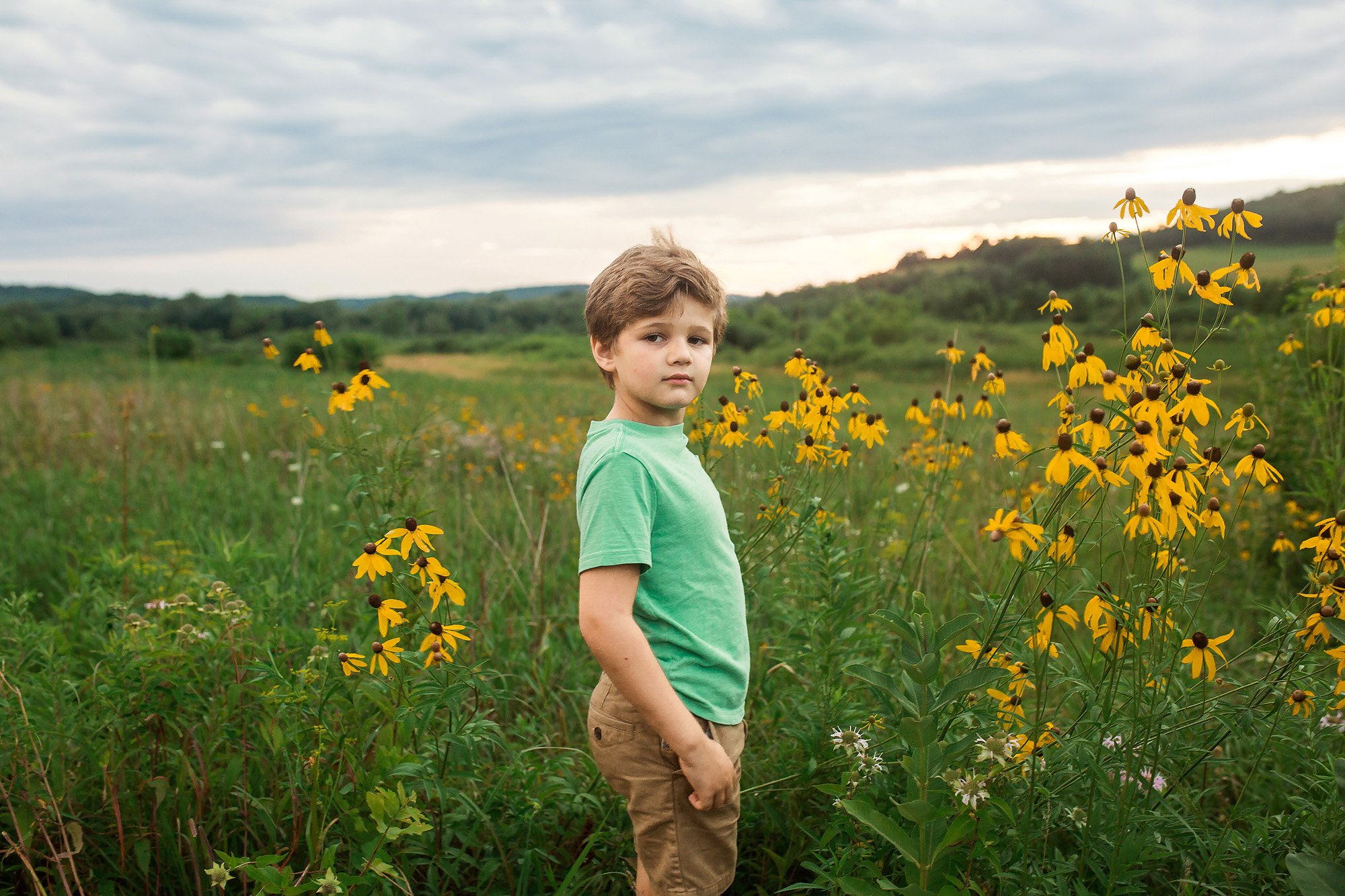 boy portrait in flower field golden hour