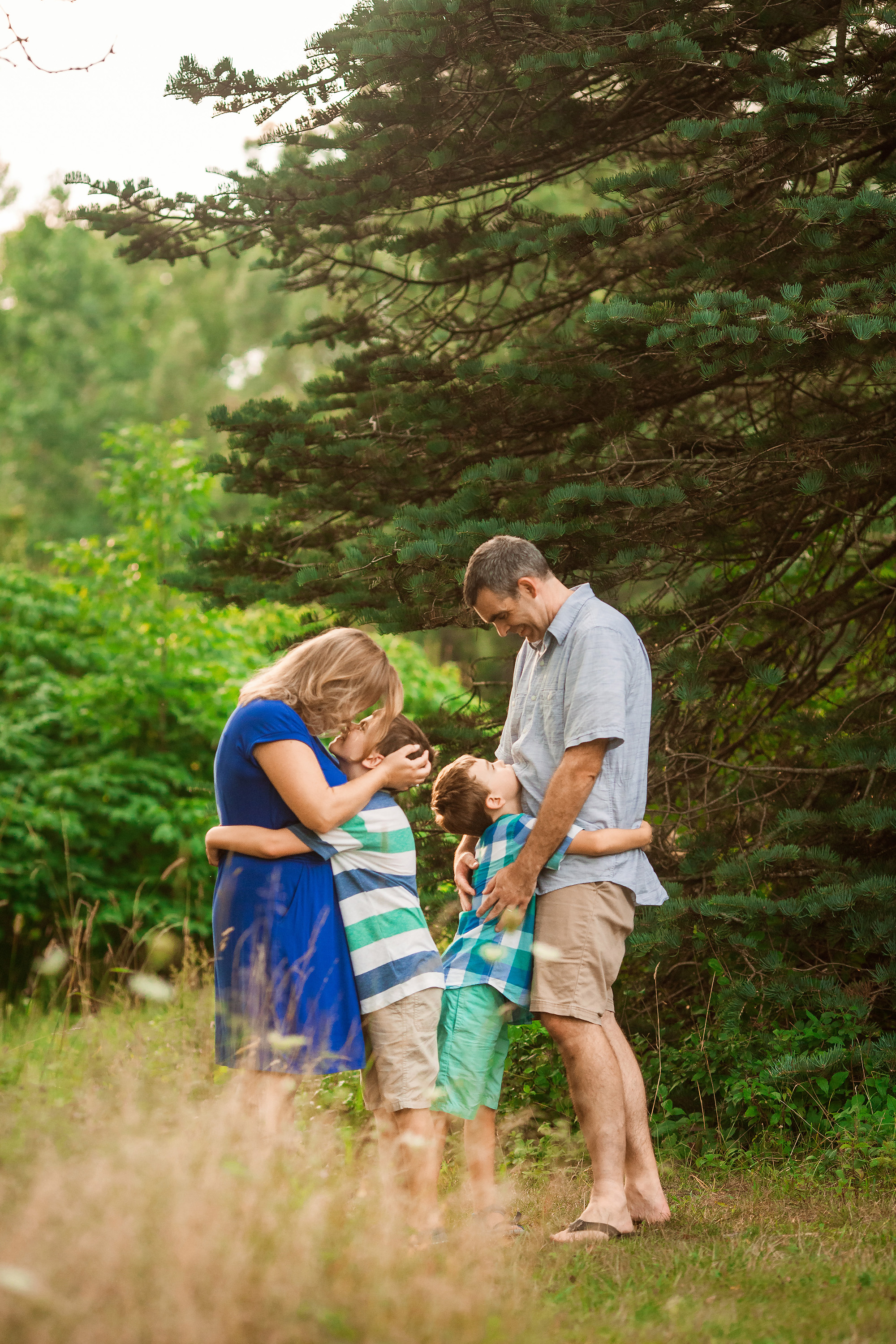 family hugging by tree evening photography