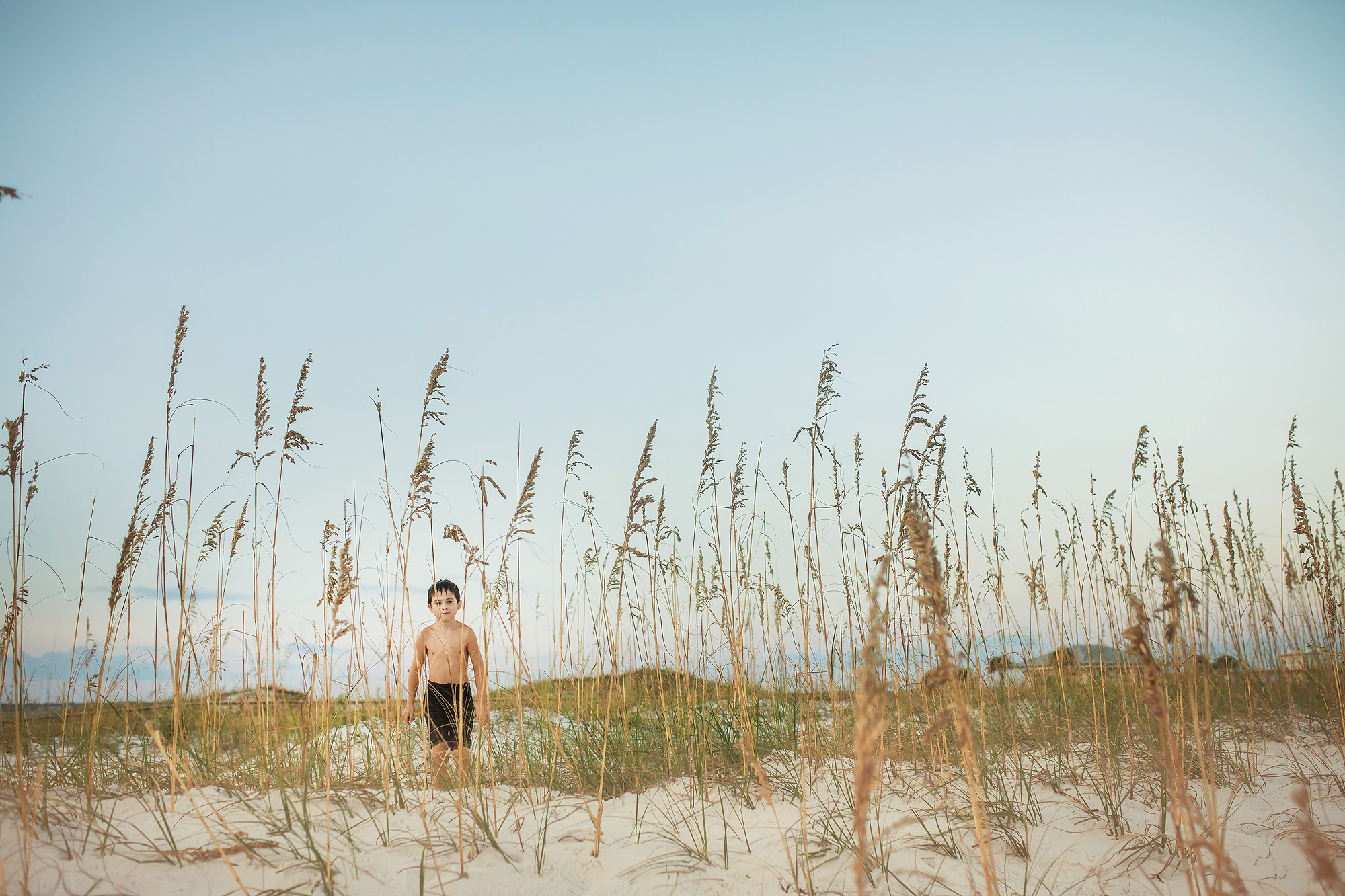 boy in tall grass beach