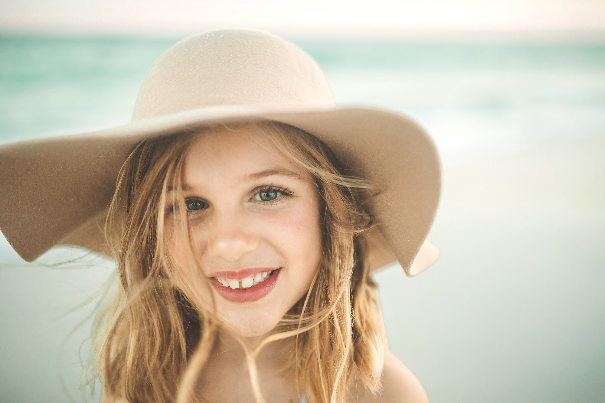 girl at beach with hat