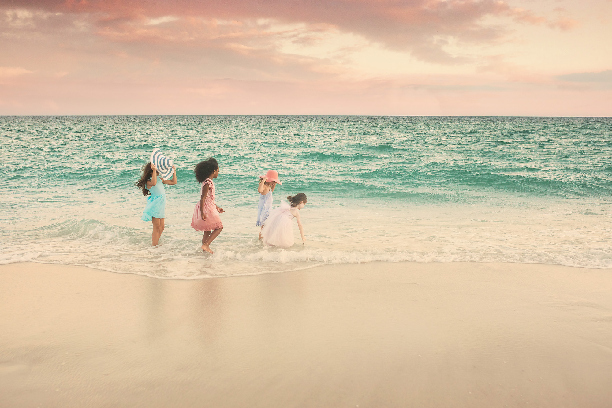 four girls at sunset by ocean