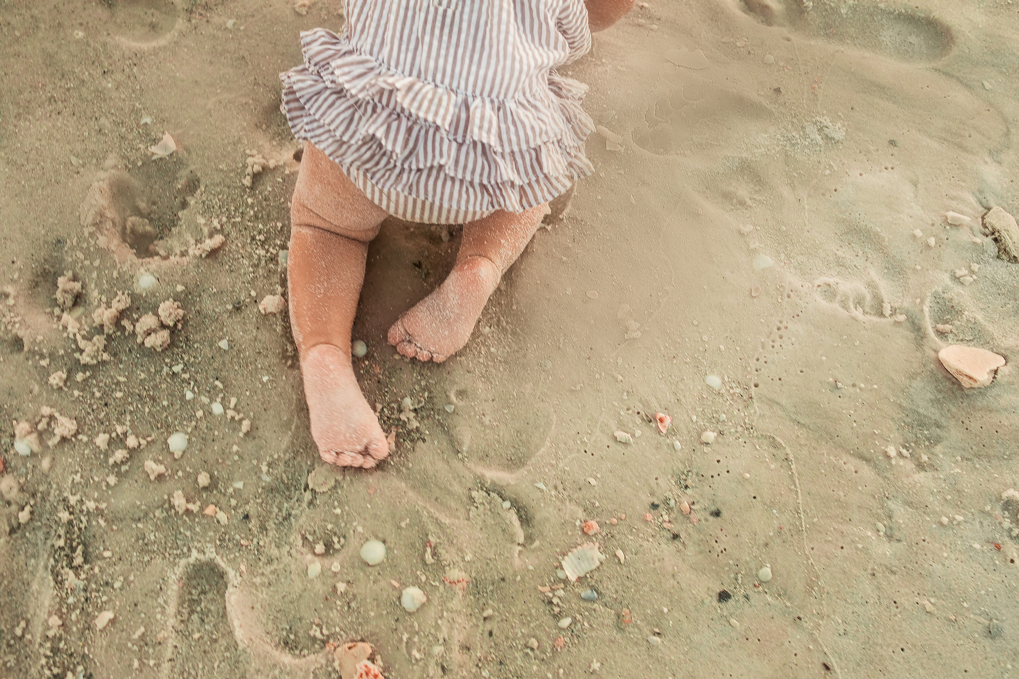 baby feet crawling on sand