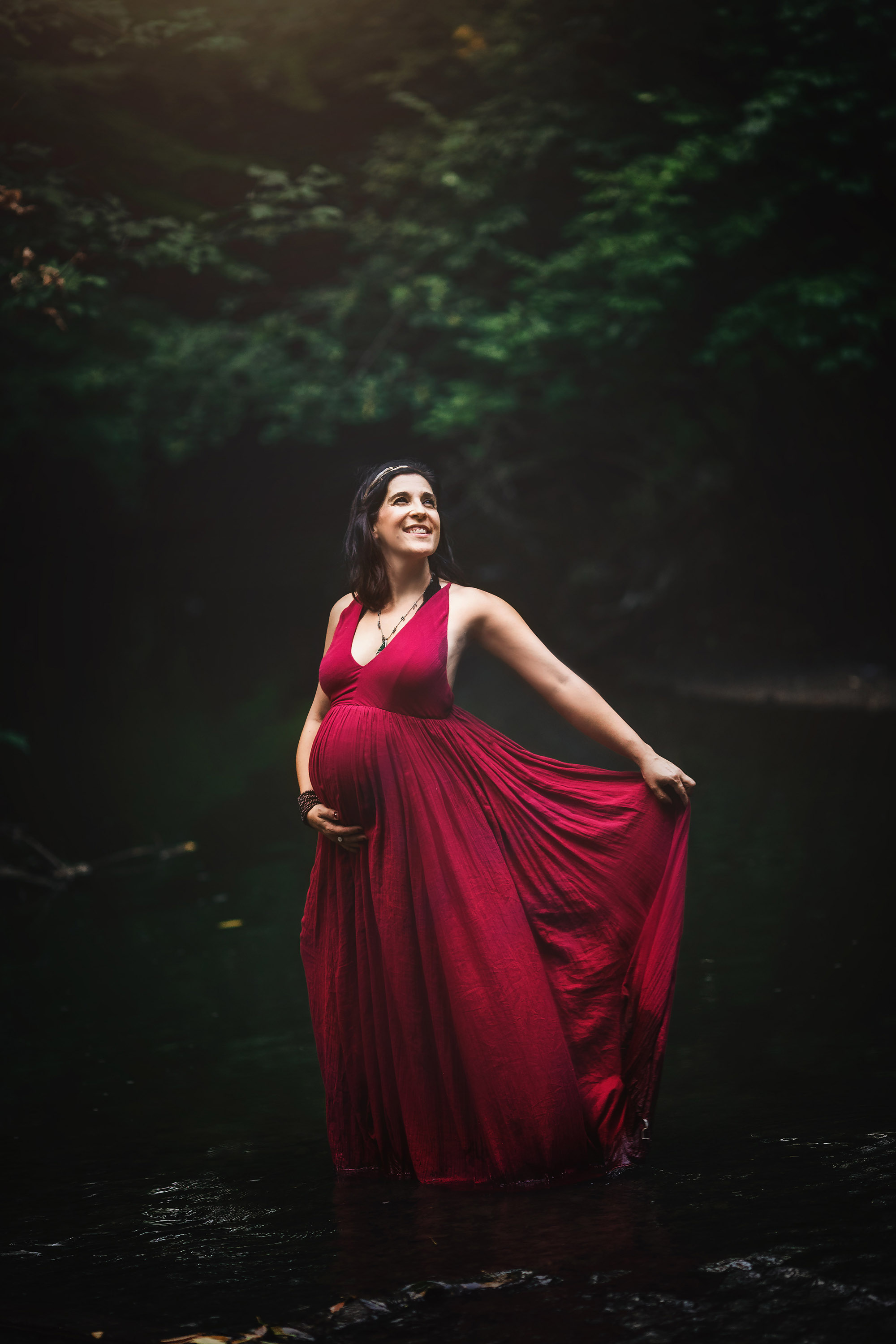 maternity in red dress in water