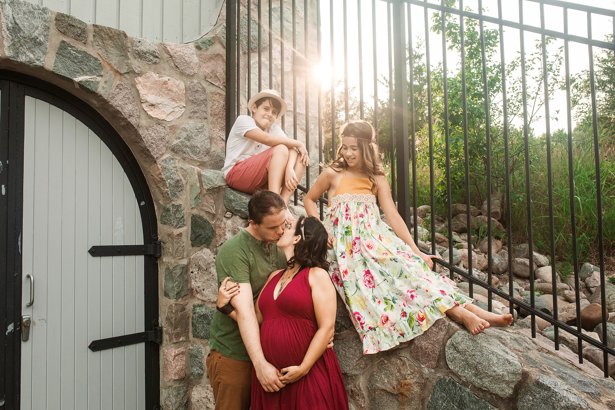 family together by wall maternity portrait