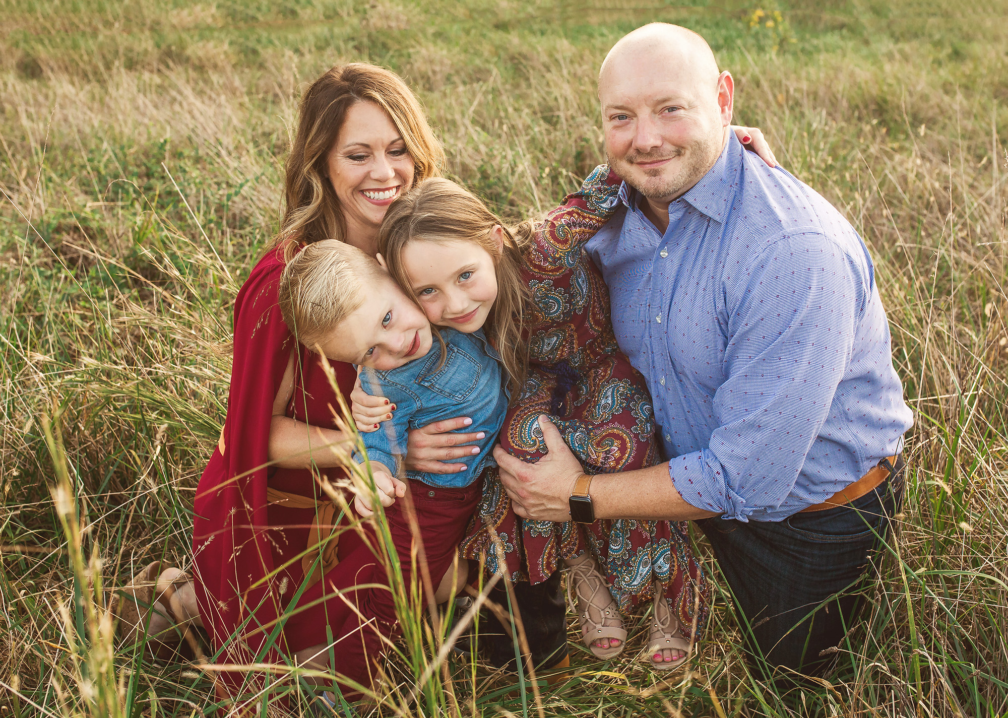 family snuggled in tall grass portrait