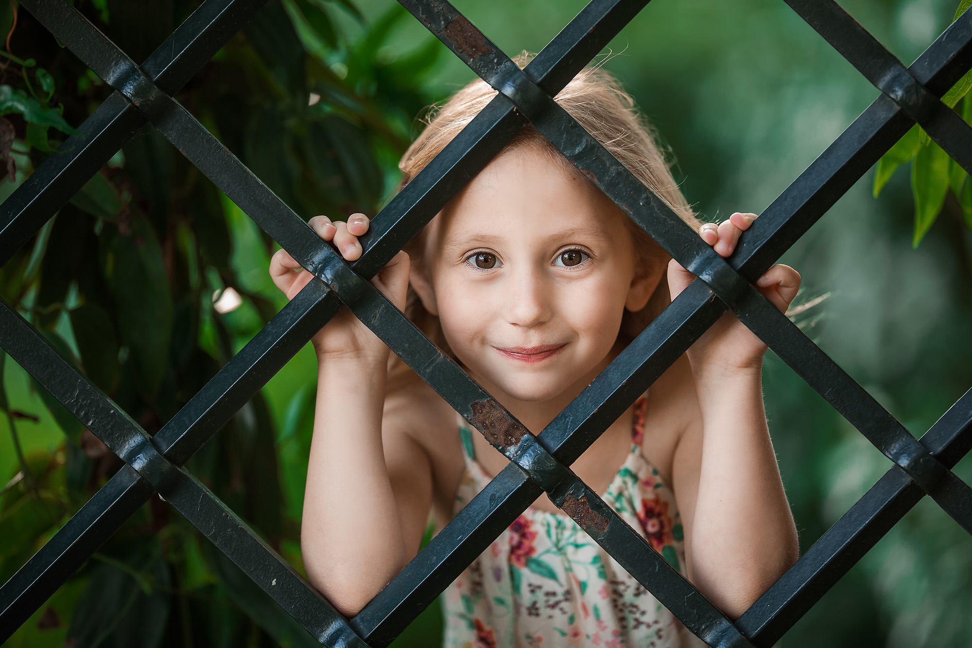 girl looking through gate portrait