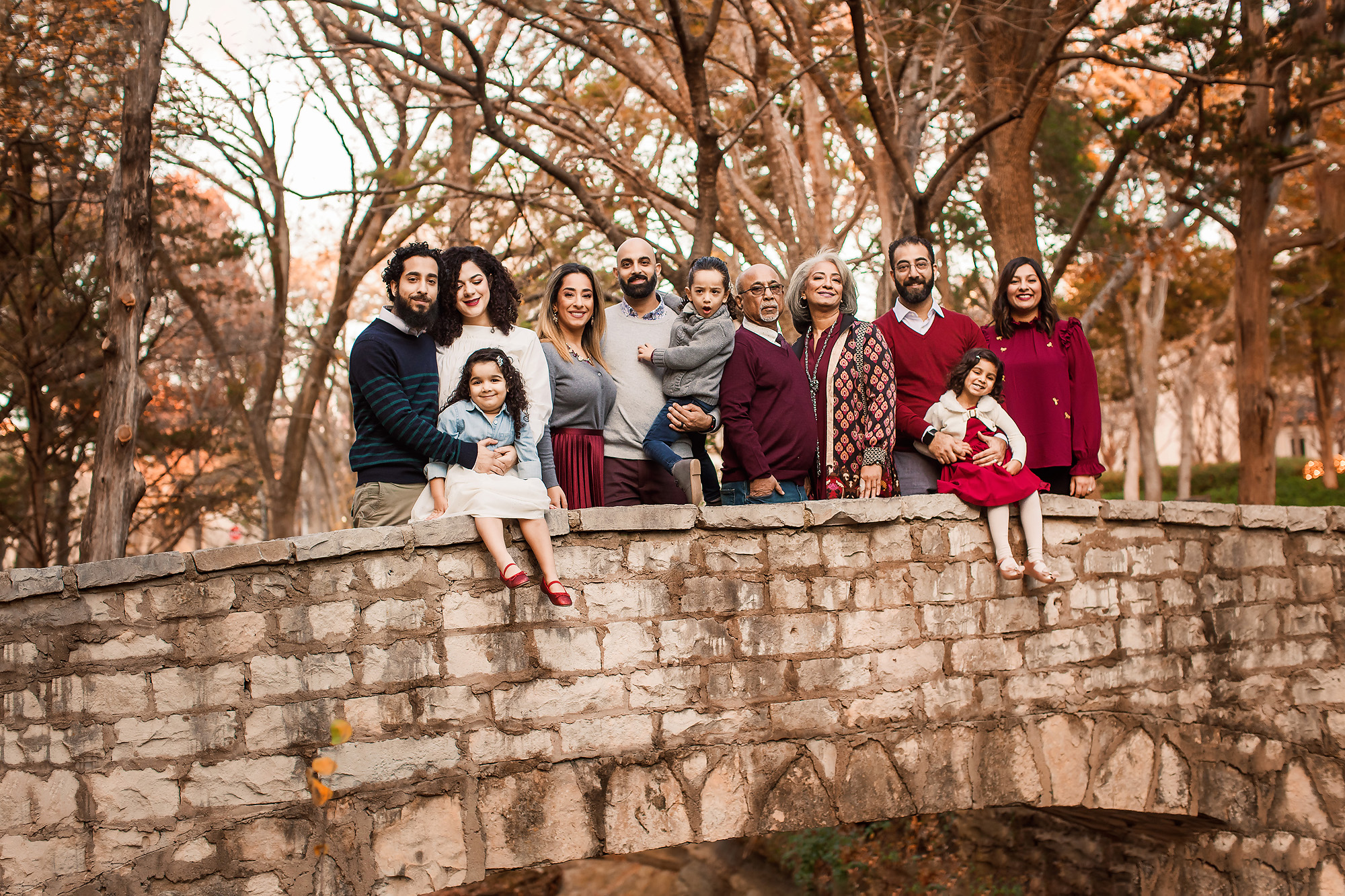 large family on bridge in fall