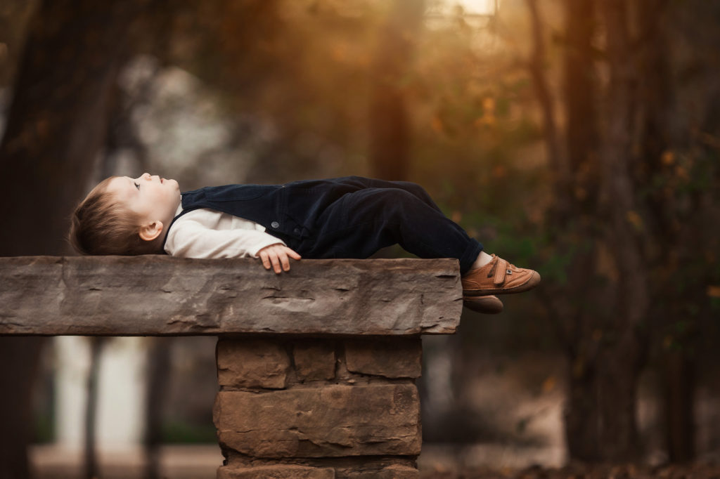 boy lying on bench looking up