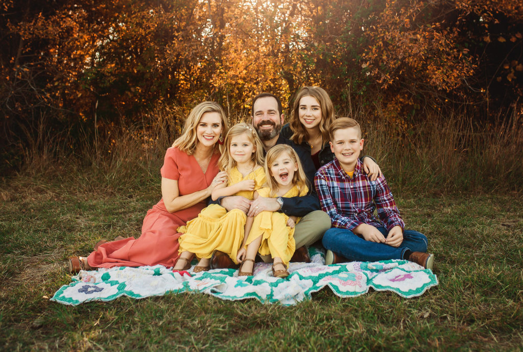 family of six smiling on blanket