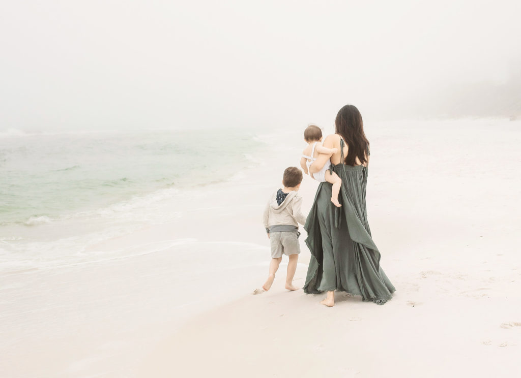 mother with children on foggy florida beach