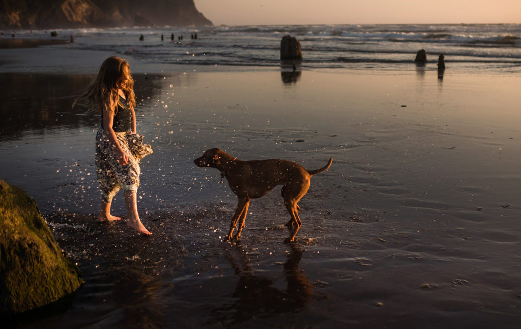 girl playing with dog beach neskowin