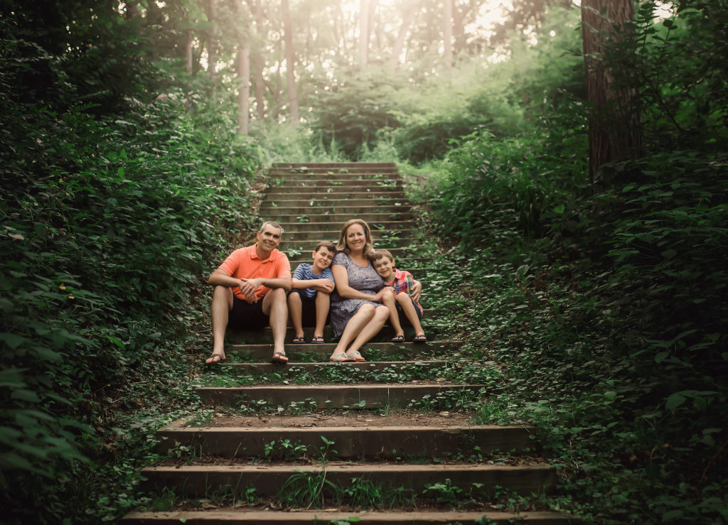 family with two boys on stairs with ivy