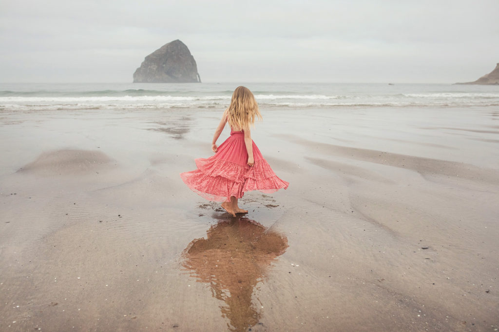 girl in pink dress oregon beach