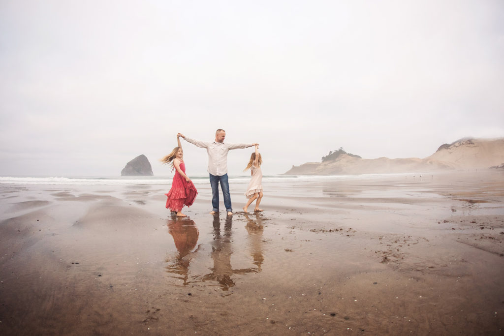 dad dancing with daughters foggy beach
