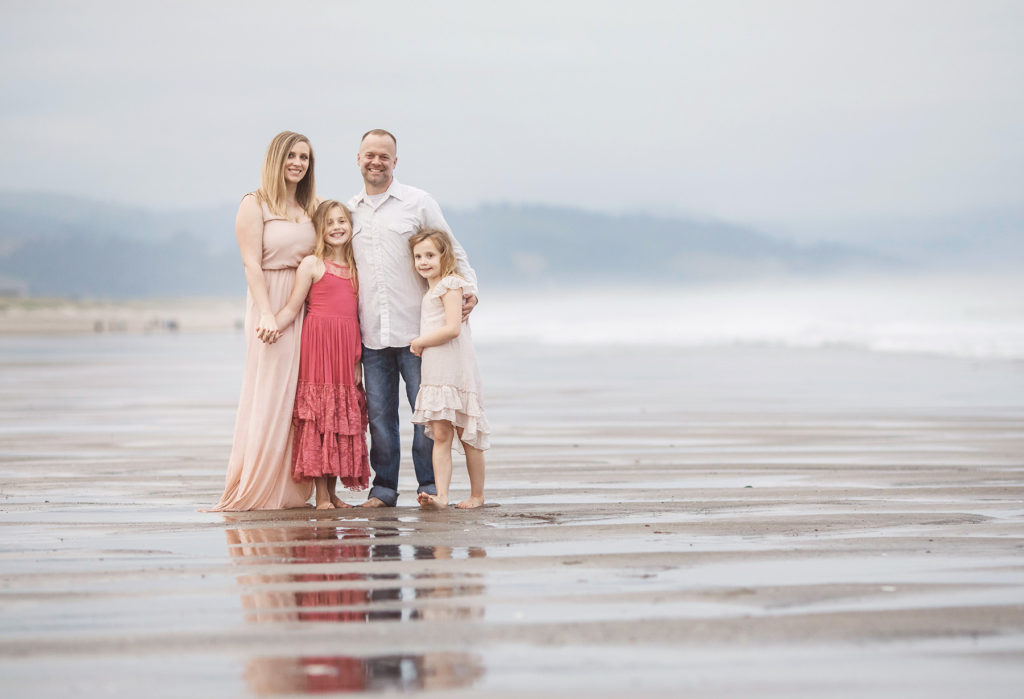 family together on foggy beach