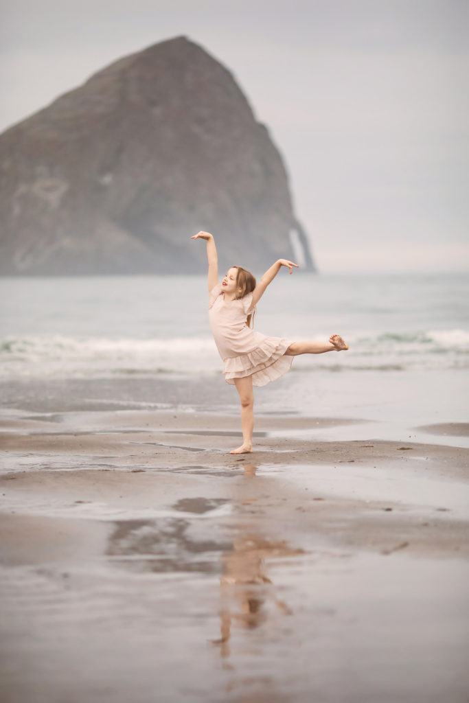 girl silly dancing oregon beach