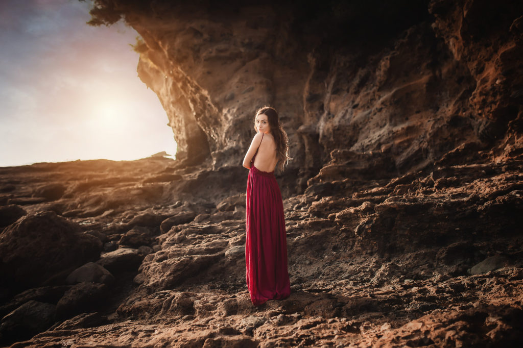 girl at sunset by rocks california