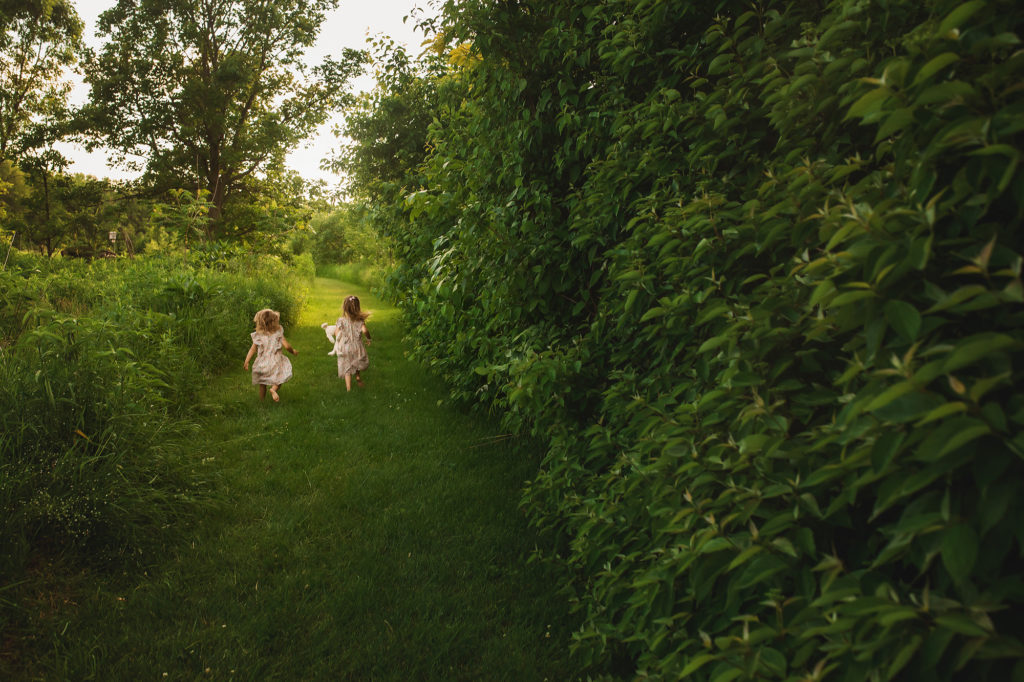 girls running on path in green grass