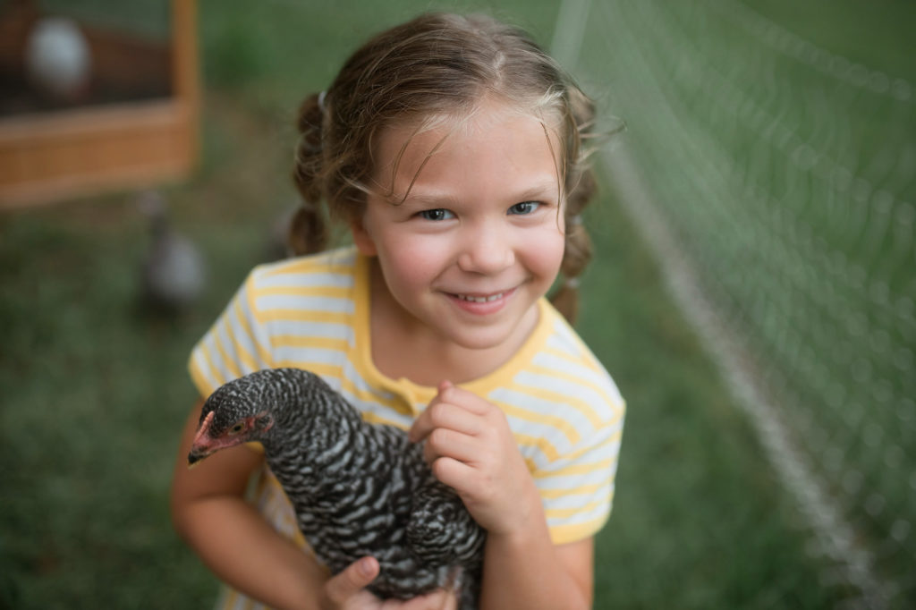 girl in yellow dress with chicken portrait